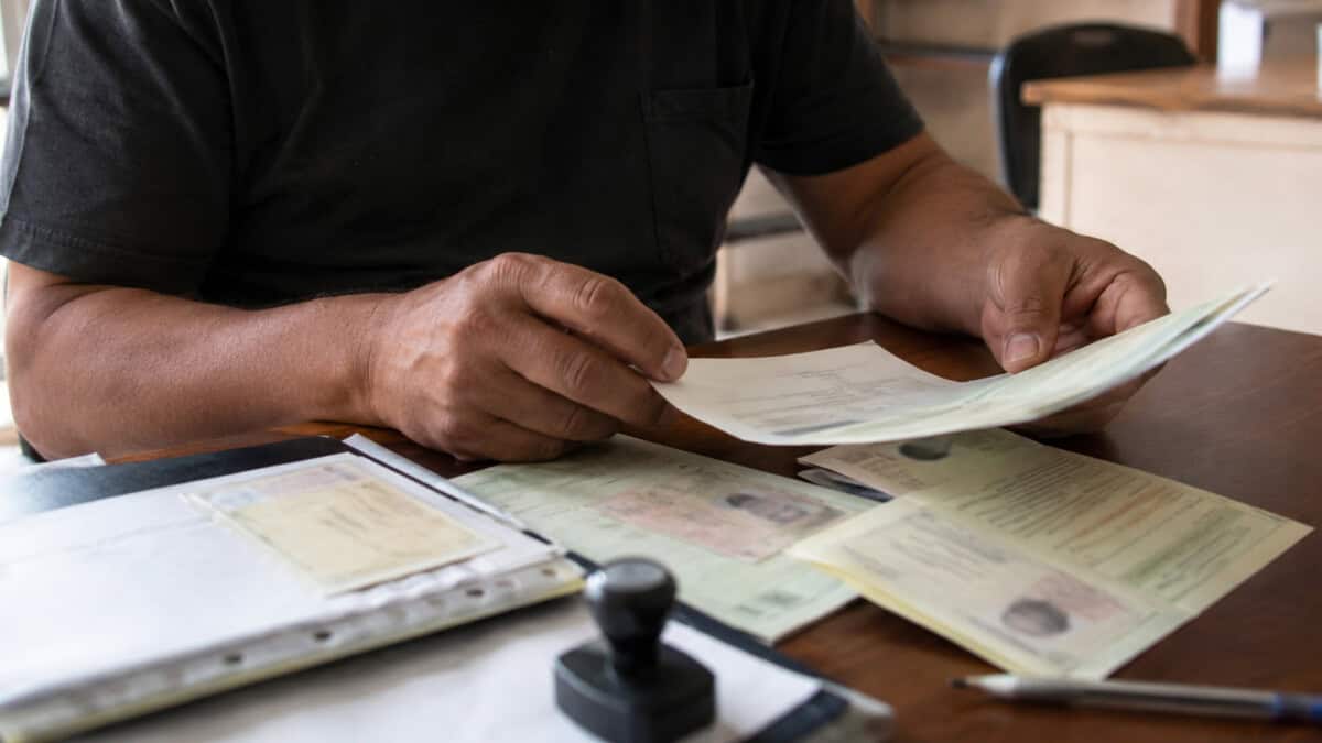 Ciudadano cubano revisa documentos relacionados con los trámites de identidad personal y domicilio.